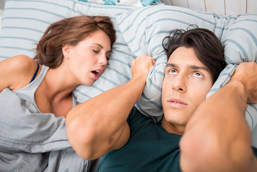 snoring young woman keeping man awake